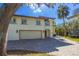 Two-story home with a tile roof, two-car garage, and paved driveway at 5010 S The Riviera St, Tampa, FL 33609