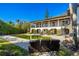 Backyard pool with outdoor seating, and balcony in lush tropical landscaping at 5010 S The Riviera St, Tampa, FL 33609