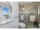 Bathroom with shower, a stylish vanity with sleek faucet, and an oval mirror at 608 Florida S Cir, Apollo Beach, FL 33572