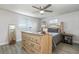 Bright bedroom features light wood-look flooring, a ceiling fan, and a large dresser at 608 Florida S Cir, Apollo Beach, FL 33572