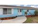 Inviting front entrance with a decorative door, clean walkway, and charming exterior details at 608 Florida S Cir, Apollo Beach, FL 33572