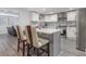 Modern kitchen featuring white cabinets, stainless steel appliances, and a stylish backsplash at 608 Florida S Cir, Apollo Beach, FL 33572