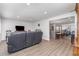 Spacious living area featuring modern furniture, open layout, and seamless access to other living spaces at 608 Florida S Cir, Apollo Beach, FL 33572