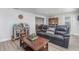 The living room features a wet bar, wood-look floors, and a comfortable black leather sofa at 608 Florida S Cir, Apollo Beach, FL 33572
