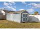 Backyard shot of the shed with double doors and adequate storage for a variety of uses at 608 Florida S Cir, Apollo Beach, FL 33572
