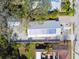 Aerial view of a house showcasing its unique roof design and the surrounding lush greenery at 652 Ohio Pl, Sarasota, FL 34236