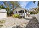 Charming home featuring a white fence, patio, and a low-maintenance gravel yard at 652 Ohio Pl, Sarasota, FL 34236