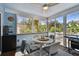 Cozy screened-in patio featuring white wicker furniture, wood floors, blue walls, and ample natural light at 652 Ohio Pl, Sarasota, FL 34236