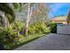 This home's backyard is an oasis, featuring tropical landscaping, a fenced area, and stone patio at 7313 Gaberia Rd, Trinity, FL 34655