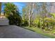 Travertine tile patio with lush landscaping creating a private backyard at 7313 Gaberia Rd, Trinity, FL 34655