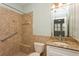 The renovated bathroom features granite countertops and a tiled shower with grab bar at 7313 Gaberia Rd, Trinity, FL 34655