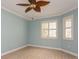 Bedroom with light blue walls and a wood look floor, trimmed with white crown molding at 7313 Gaberia Rd, Trinity, FL 34655