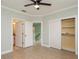 Bedroom boasts wood floors and a large closet near a half bath at 7313 Gaberia Rd, Trinity, FL 34655