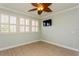 Bright bedroom features stylish wood-look flooring and a unique ceiling fan at 7313 Gaberia Rd, Trinity, FL 34655