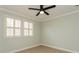 Sunlit bedroom with plantation shutters offering natural light and wood-look flooring at 7313 Gaberia Rd, Trinity, FL 34655