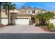 Charming home featuring a three car garage, tile roof, and beautifully landscaped front yard at 7313 Gaberia Rd, Trinity, FL 34655