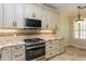 Kitchen featuring stainless steel appliances, granite countertops and custom cabinetry at 7313 Gaberia Rd, Trinity, FL 34655