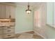 Kitchen featuring travertine backsplash, granite countertops and custom cabinetry at 7313 Gaberia Rd, Trinity, FL 34655