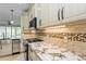 Kitchen featuring stainless steel appliances, granite countertops and custom cabinetry at 7313 Gaberia Rd, Trinity, FL 34655
