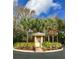 Quaint community mail kiosk surrounded by lush landscaping and mature palm trees at 7313 Gaberia Rd, Trinity, FL 34655