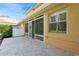 Covered patio boasts stone flooring, screen doors, and a great view of the fenced backyard at 7313 Gaberia Rd, Trinity, FL 34655