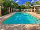 Beautiful community pool surrounded by lush landscaping and comfortable lounge seating at 7313 Gaberia Rd, Trinity, FL 34655
