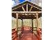 Charming covered wooden walkway in a community surrounded by beautiful trees and foliage at 7313 Gaberia Rd, Trinity, FL 34655