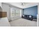 A loft featuring a ceiling fan, carpet, and a large window with natural light and a gray sofa at 7704 S Sparkman St, Tampa, FL 33616