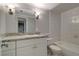 Bathroom features a vanity with a gray and white countertop, alongside a toilet and bathtub at 8914 N Ola Ave, Tampa, FL 33604