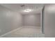 This room features gray paint, tile flooring, and a ceiling light at 8914 N Ola Ave, Tampa, FL 33604