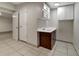 Functional kitchenette area features cabinets, sink, and tile floors at 8914 N Ola Ave, Tampa, FL 33604