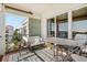 Cozy outdoor balcony featuring patio furniture with views of the water and surrounding buildings at 1026 Bellasol Way # 4403, Apollo Beach, FL 33572