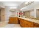 Spacious bathroom with double vanities, granite countertops, a large mirror, and a walk-in shower at 1026 Bellasol Way # 4403, Apollo Beach, FL 33572