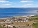 Scenic aerial view of a beach and waterfront, showing a park area and distant skyline at 1026 Bellasol Way # 4403, Apollo Beach, FL 33572