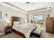 Bedroom with tray ceilings and a private balcony overlooking the waterfront, offering a serene retreat at 1026 Bellasol Way # 4403, Apollo Beach, FL 33572