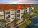 Three-story waterfront condo featuring balconies, neutral paint, and a terracotta-colored tile roof at 1026 Bellasol Way # 4403, Apollo Beach, FL 33572