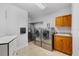 Modern laundry room with stainless steel appliances and ample counter space at 1026 Bellasol Way # 4403, Apollo Beach, FL 33572