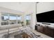 Open living room featuring a large window with beautiful waterfront views and a sliding glass door to a balcony at 1026 Bellasol Way # 4403, Apollo Beach, FL 33572