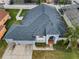 Aerial view of house featuring a large lawn, well-kept landscaping, and a large roof at 10312 Riverburn Dr, Tampa, FL 33647