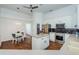 Open kitchen featuring stainless steel appliances, white cabinetry, island, and adjacent dining area at 10312 Riverburn Dr, Tampa, FL 33647