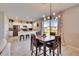 Open concept dining area with modern lighting and a seamless transition to the gourmet kitchen at 10421 Laguna Plains Dr, Riverview, FL 33578