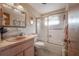 Bathroom featuring a vintage pink sink, commode, shower with glass door and tile flooring at 1133 Powersong St, Holiday, FL 34690