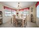 Dining room with tile flooring, pendant lighting, three windows, and decorative shelving at 1133 Powersong St, Holiday, FL 34690