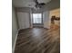 Bedroom with hardwood floors, closet, and connecting doorway to kitchen at 11638 Hidden Hollow Cir, Tampa, FL 33635