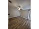 Bedroom with hardwood floors, neutral walls, and ceiling fan at 11638 Hidden Hollow Cir, Tampa, FL 33635