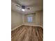 This bedroom features a ceiling fan and new wood flooring, and window at 11638 Hidden Hollow Cir, Tampa, FL 33635