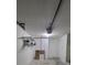 Spacious garage with overhead storage and shelving units, painted white at 11638 Hidden Hollow Cir, Tampa, FL 33635