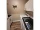 This laundry room includes washer, dryer, sink and storage at 11638 Hidden Hollow Cir, Tampa, FL 33635