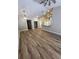 Spacious living area showcasing hardwood floors, modern lighting and neutral color scheme at 11638 Hidden Hollow Cir, Tampa, FL 33635