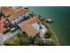 Stunning aerial view of waterfront estate with a private pool, boat dock, and lush landscaping at 11697 Grove St, Seminole, FL 33772